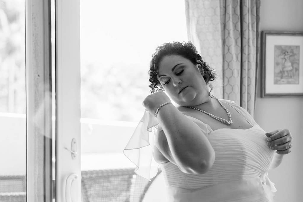 Bride fixing her veil.