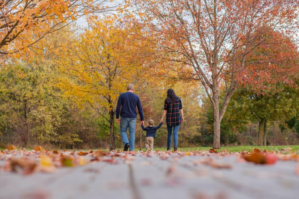 Father, mother, son walking down a path