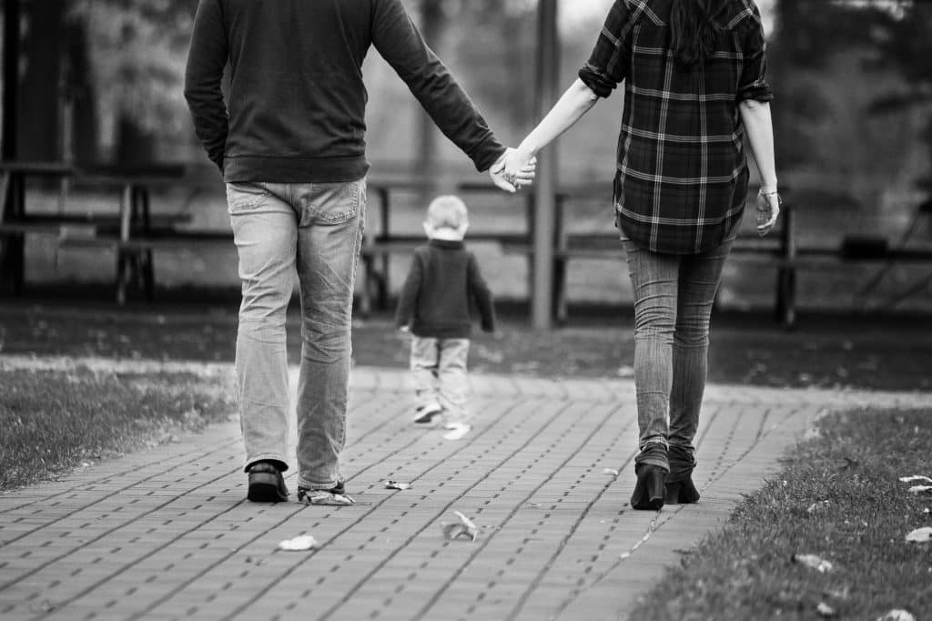 Mother and father holding hands.