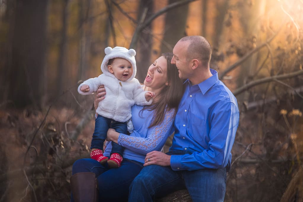 Parents and toddler laughing.