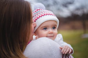 Mother holding her daughter.