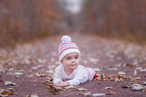 Adorable toddler lying on the ground.