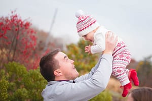 Father picking up his daughter.